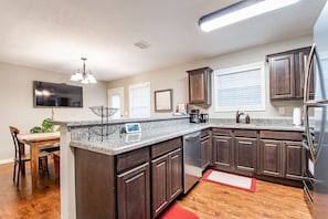 Granite countertops and fully stocked kitchen.