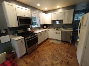 kitchen with gas range, dishwasher, fridge/freezer&almost all you need to cook