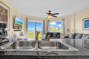 This kitchen is open to the living room and comes with views