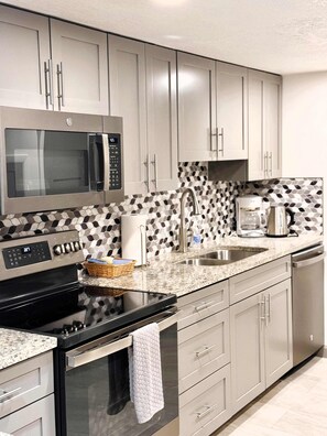 Fully equipped kitchen with stainless steel appliances,