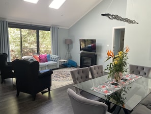 Open dining and lounge with Skylights and cathedral ceiling