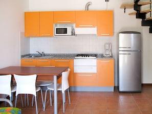 Room, Orange, Kitchen, Furniture, Property, Cabinetry, Major Appliance, Kitchen Stove, Countertop, Floor