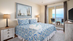 Master bedroom with king sized bed and access to baclony
