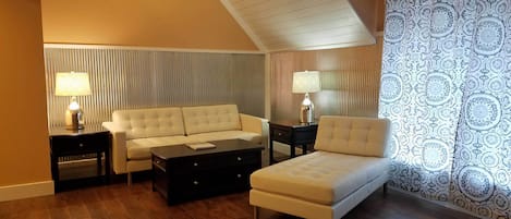 Living room area with large window and work station coffee table.