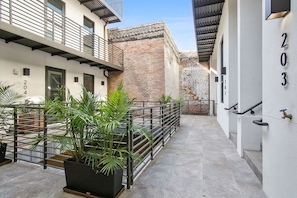 Elegant courtyard patio with natural light and exposed brick.