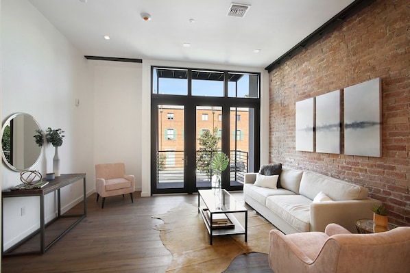 Turnkey and designer furnished with spacious living area and exposed brick. 