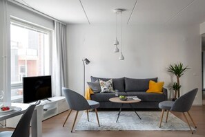 Open plan living room with a stylish Nordic decor.