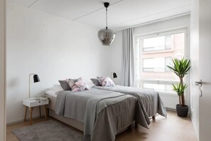 Bedroom 1 with high quality beds and a lovely view to the neighbourhood.