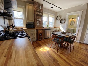 Warm 1st floor kitchen. New cabinets + counters w/original heart pine floors 🤩