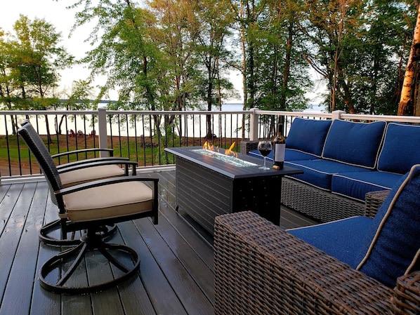 Upper deck seating and gas firepit. Upstairs bedroom opens to upper deck. 