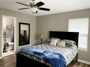 Master bedroom with queen bed and attached bathroom