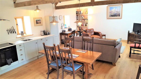 Open plan kitchen/ lounge.  Oak floor and original vaulted beams