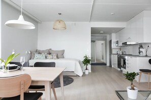 Open plan kitchen with a living room, dining area, and an alcove.