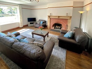 Welcoming living room with open fire | Penfound Country Cottage, Poundstock, near Bude