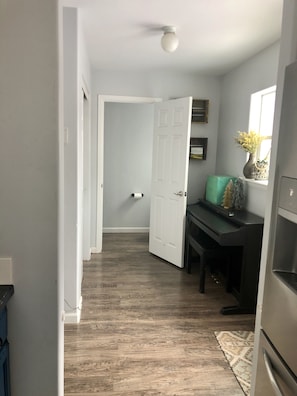 Piano room leading to main floor bathroom