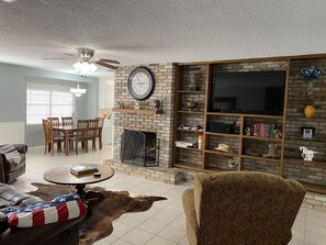 View of Living Room area from front door. TV, Books, Games, Fireplace, couches