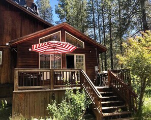 Small deck off the living room with gas grill and dining table perfect for outdoor dining or sitting down with a good book