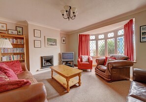 Spacious lounge with large bay window.