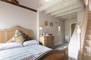 View from foot of stairs to mezzanine across main bedroom.