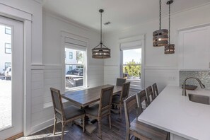 Kitchen seating includes a built in bench, four chairs, and four bar stools (1)
