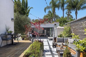 Private side garden, coffee mornings, cocktails at night, twinkle lights. 