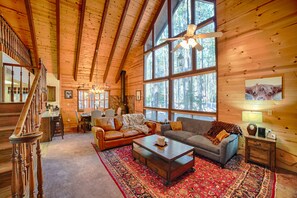 Cozy Modern Rustic Living Room with vaulted ceiling and large picture windows.