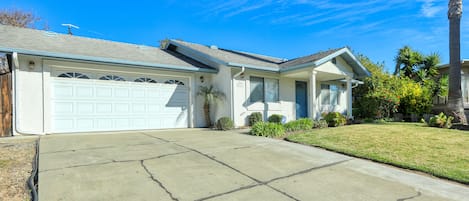 Distant view from the street of the driveway at this rental unit