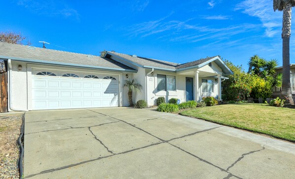 Distant view from the street of the driveway at this rental unit