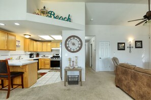 Vacation rental unit's wide view of kitchen, hallway, and living room