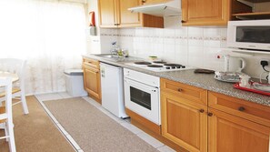 Compact well equipped kitchen, with full size cooker, fridge, microwave etc.