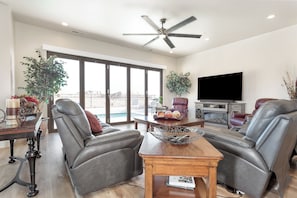 Family room featuring comfortable leather seating and a large flat screen tv