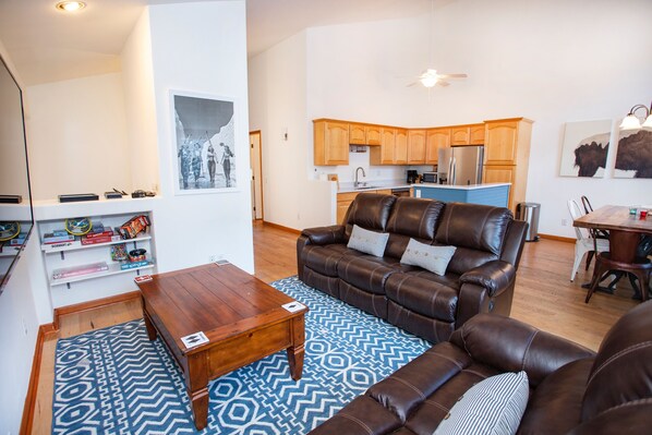 Airy, bright and spacious living room with 70' flat screen TV
