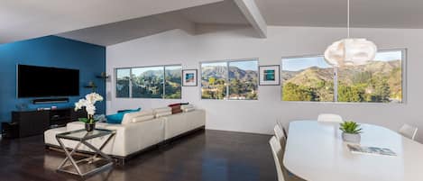 Spacious and bright living room, 65" Sony 4K TV, Sonos sound system and sweeping views of the Hollywood sign and beyond.