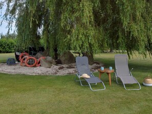 Plant, Furniture, Chair, Land Lot, Tree, Grass, Shade, Outdoor Furniture, Armrest, Landscape