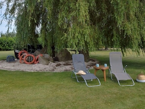 Plant, Furniture, Chair, Land Lot, Tree, Grass, Shade, Outdoor Furniture, Armrest, Landscape