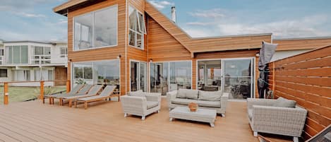 Enormous beach facing deck with plenty of seating for all and a huge umbrella. 