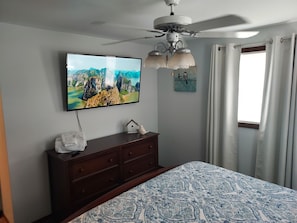 Master bedroom with king bed and 55"  smart tv