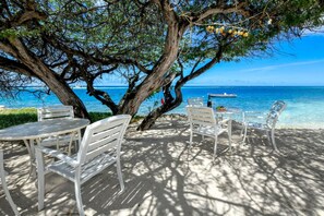 Beachside seating perfect for enjoying a drink, a meal, or simply relaxing with a good book.