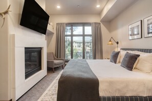 Primary bedroom features a king bed, ensuite bathroom, fireplace, and TV.