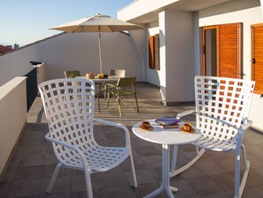 Spacious terrace with sitting area and sea view