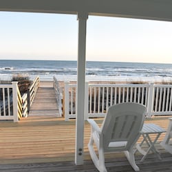 Covered deck overlooking beach and ocean with private beach access