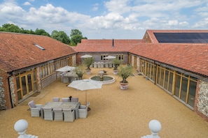 Fallow Folly, Little Massingham: The courtyard with Fallow Folly entrance on the left, and swimming pool on the right