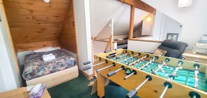 Loft with foosball game table, and sleeping