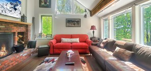 2 Sofas with large wood-burning fireplace.