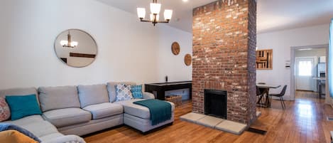 Living room with dining area and shuffle board.