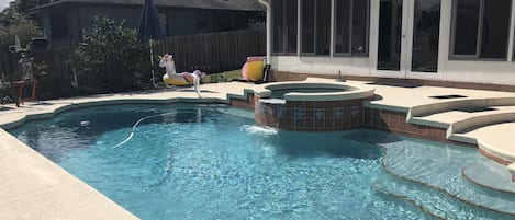 Backyard pool oasis with waterfall feature.