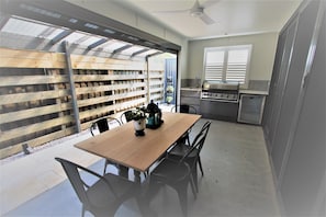 Outdoor BBQ and patio beside the lounge.