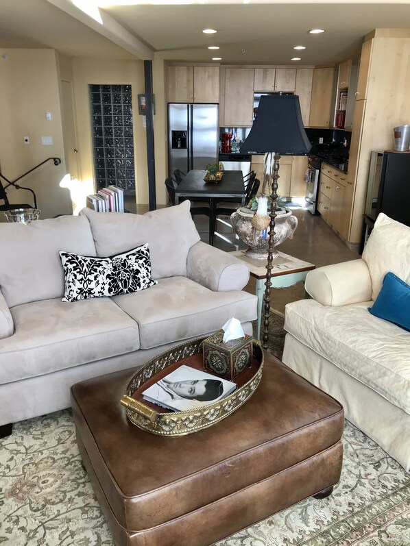 Living area with full-size kitchen behind.