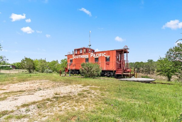 Stay in a unique Southern Pacific caboose-perfect for a relaxing, rustic getaway in the Texas countryside!
