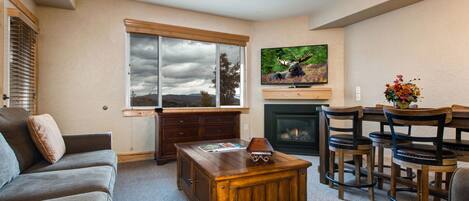 Spacious living area with fireplace and large 55" high def tv.